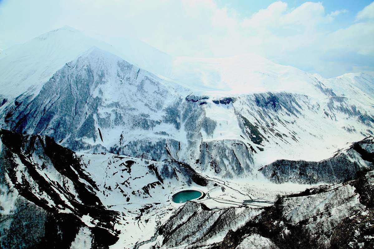 snow aerial view photography of snow-covered mountain under cloudy sky during daytime georgia