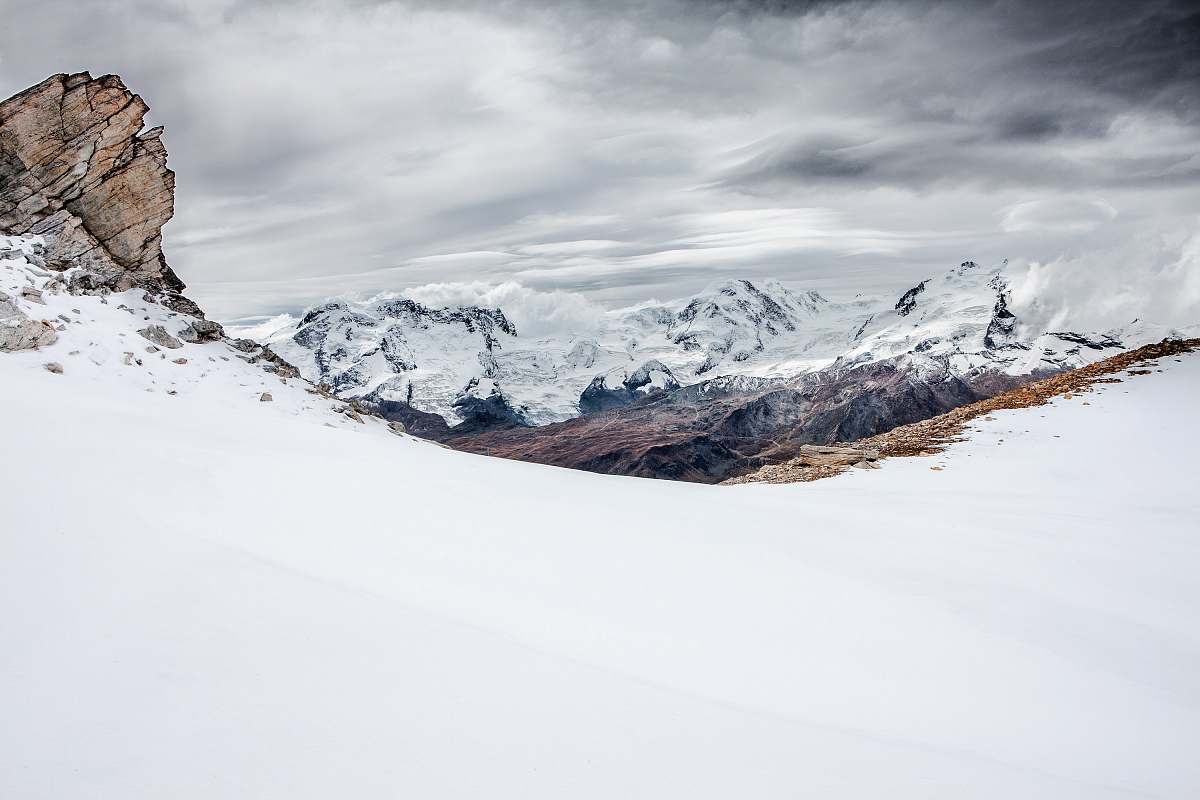 snow brown mountain covered with snow under dark cloudy sky nature