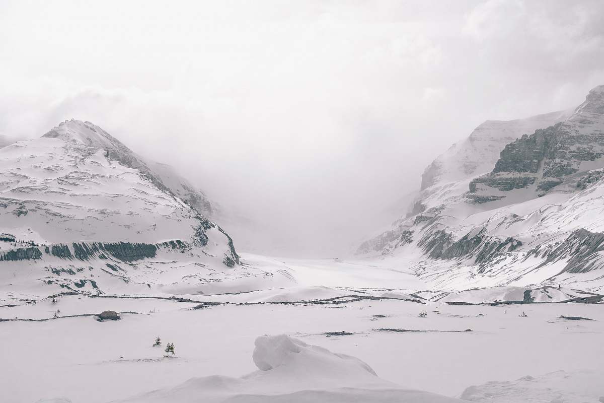 snow gray sand field and mountains glacier