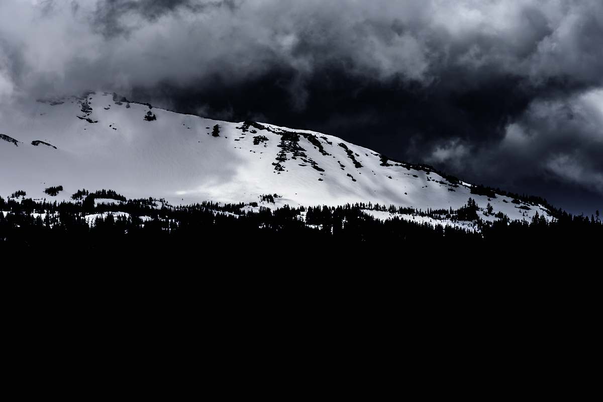 sky grayscale photo of mountain during winter outdoors