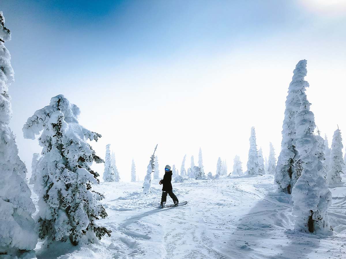 snow man walking on snow outdoors