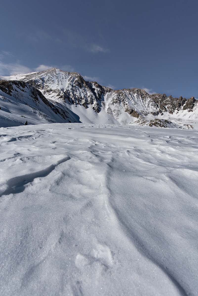 Experience the serene beauty of a majestic snow-covered mountain set in a breathtaking natural landscape. This stunning outdoor scene showcases the tranquility and grandeur of winter, making it an ideal backdrop for nature-themed projects, travel brochures, or inspirational quotes. Perfect for showcasing winter adventures, outdoor activities, and the beauty of untouched landscapes.
