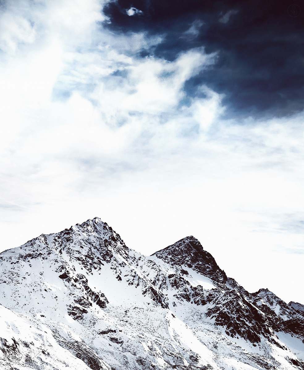 nature mountain filled of snow under gray cloud alps
