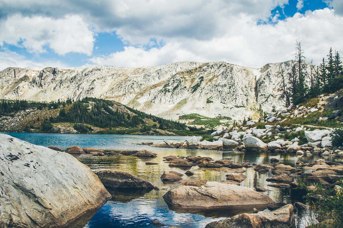 landscape mountain range with lake rocks