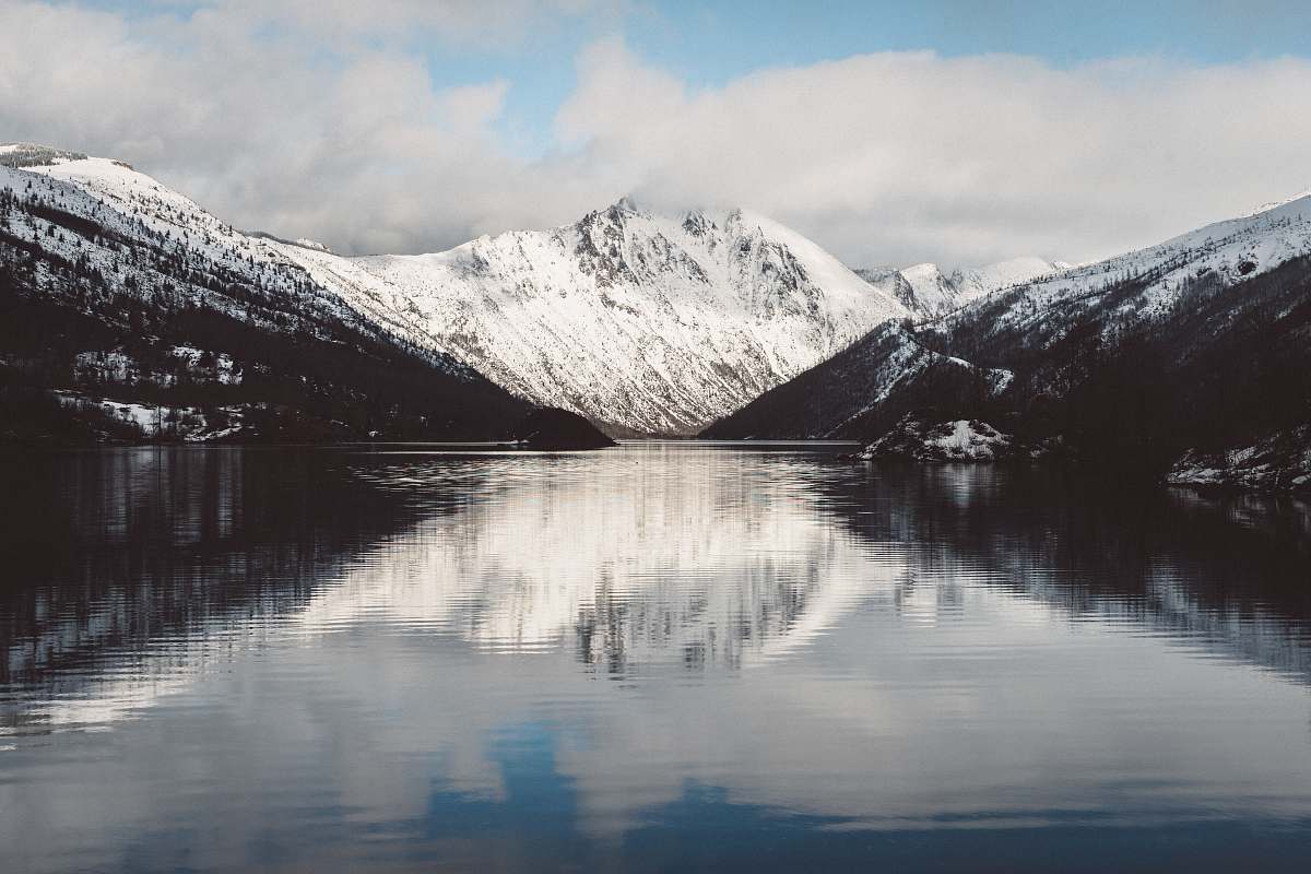 ice reflective photography of snow-covered mountain snow
