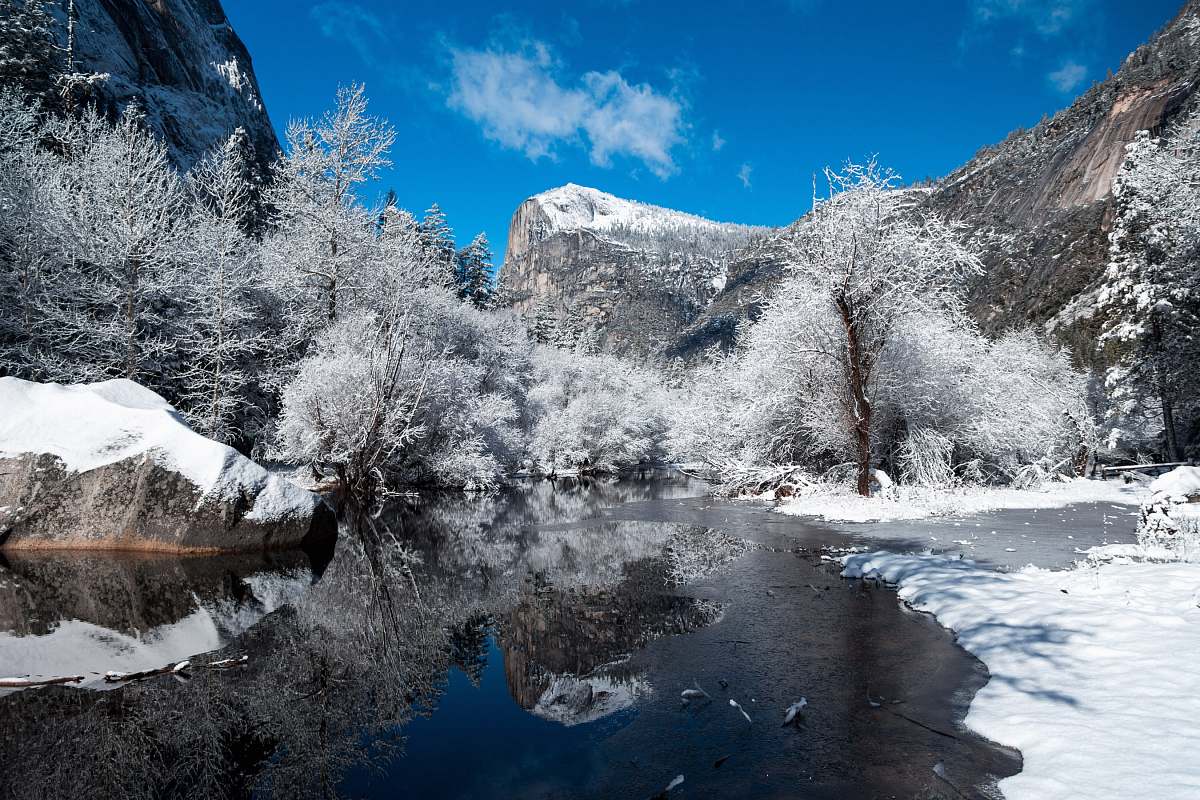 snow snow capped mountain near river at daytime blue