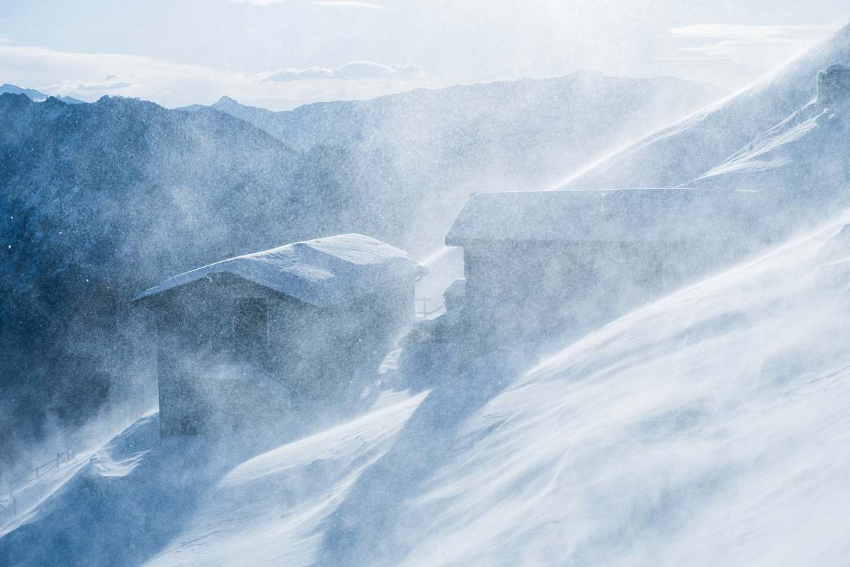 snow two cabins covered with snow ice