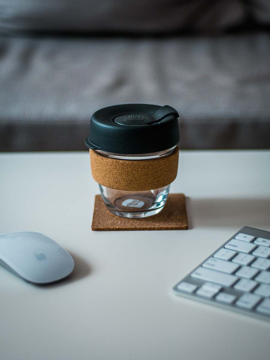 keyboard covered jar between Magic Mouse and Keyboard on desk glass
