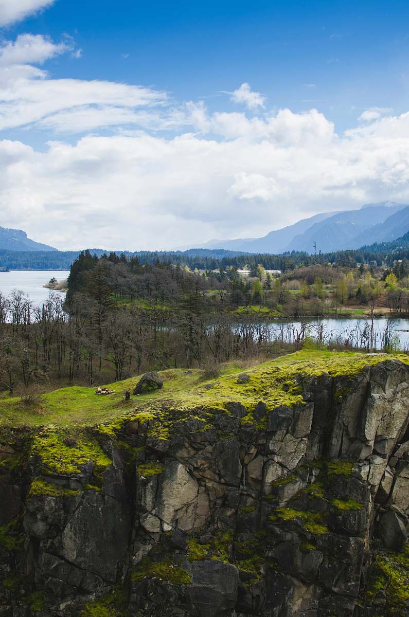landscape aerial photo of green cliff and river under blue sky during daytime oregon