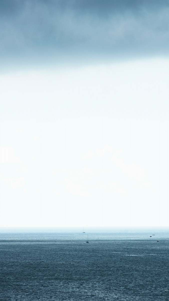 ocean body of water under gray cloudy sky sea