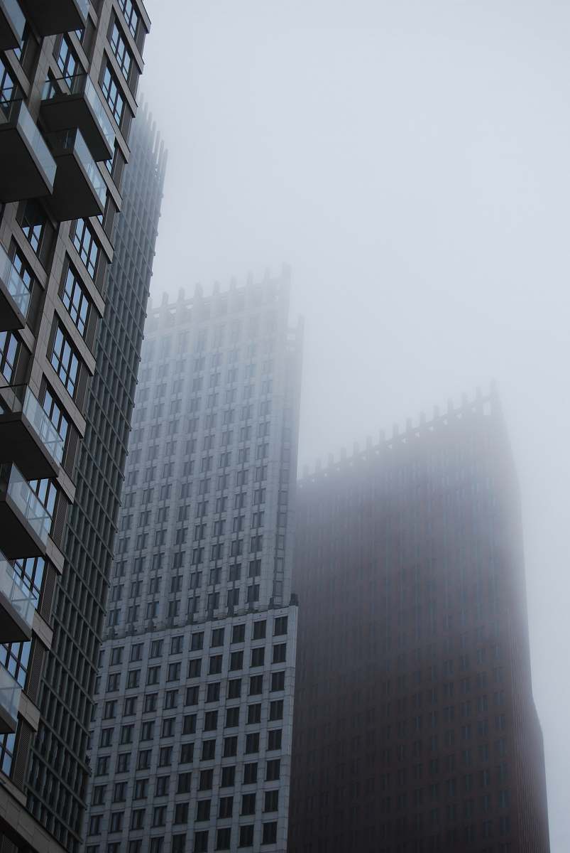 grey city with high-rise buildings during foggy season city