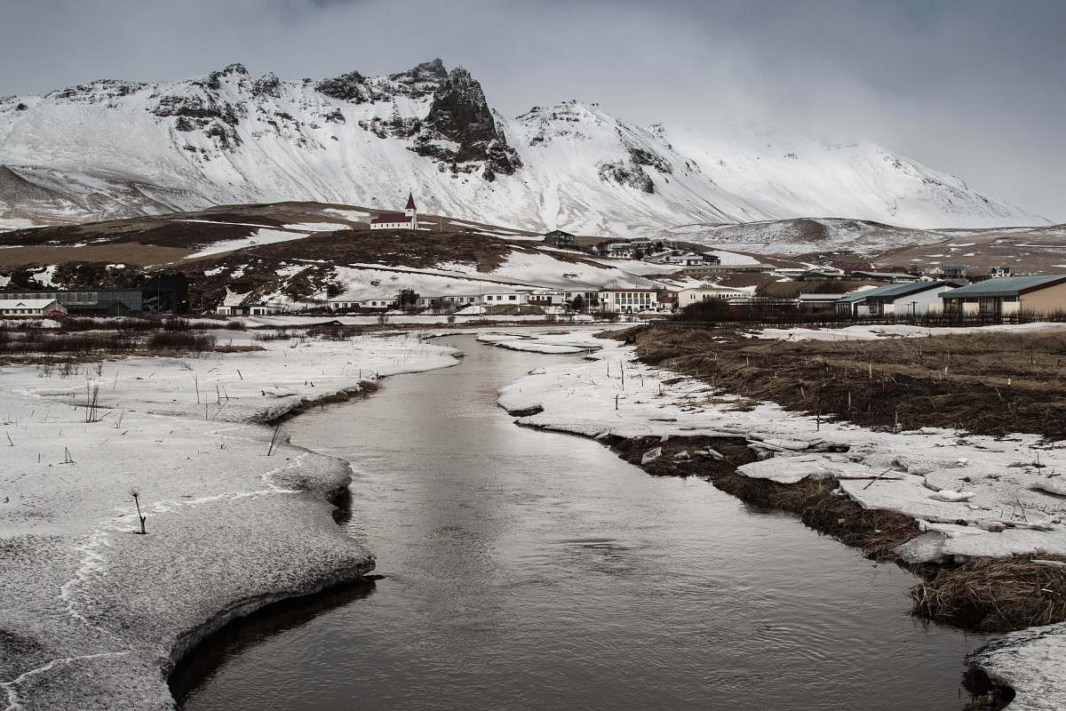 mountain field covered with about to melt snow alps