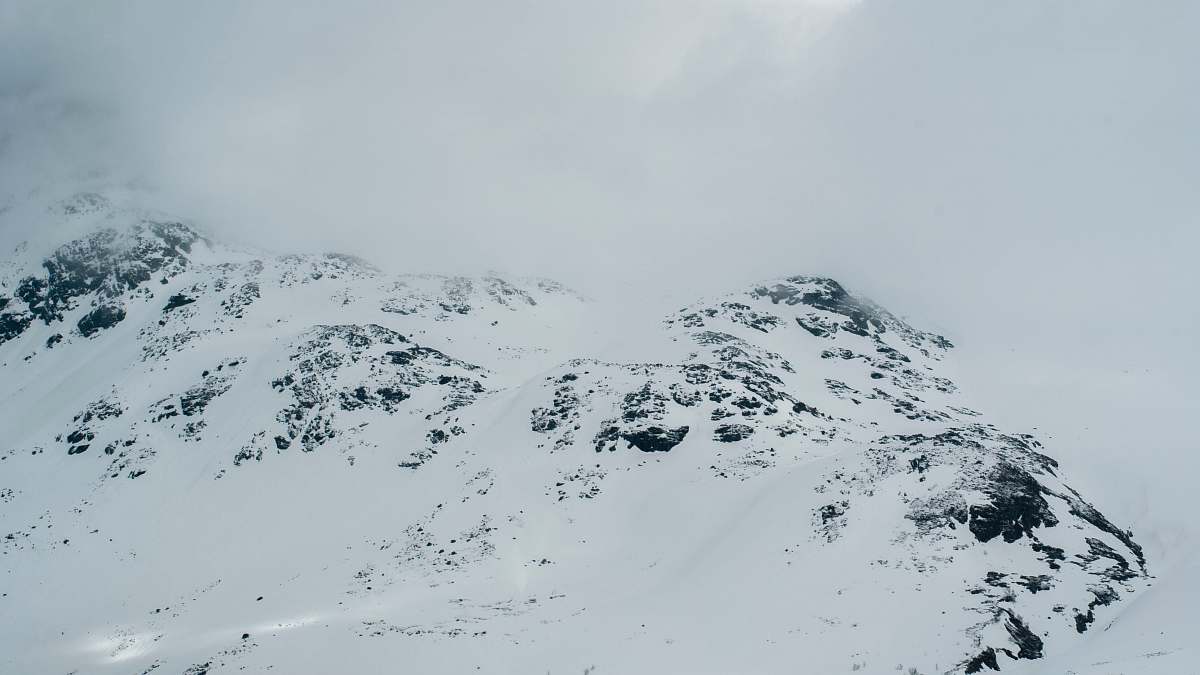 mountain gray rock covered with white snow grey