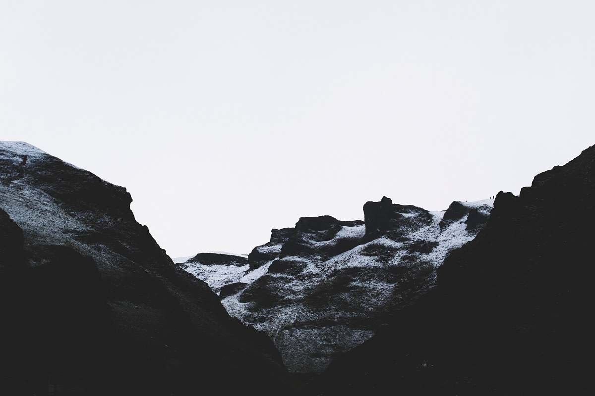 mountain grayscale photo of rock formation alps
