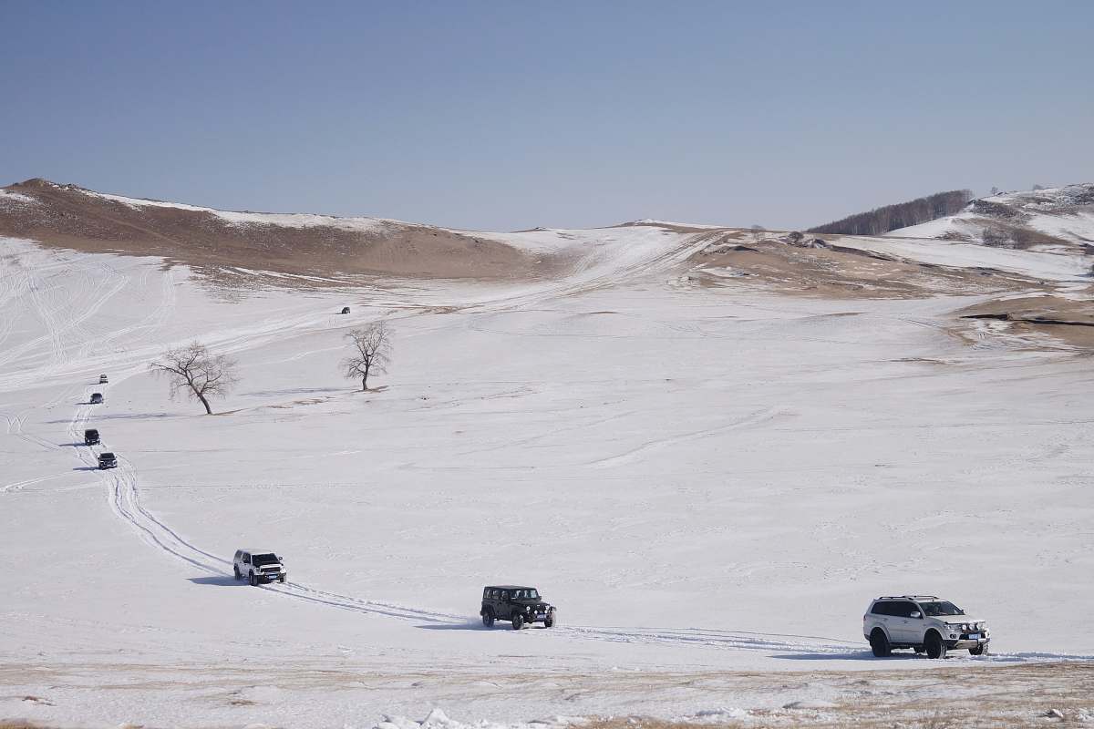 grey group of vehicles on white sand soil