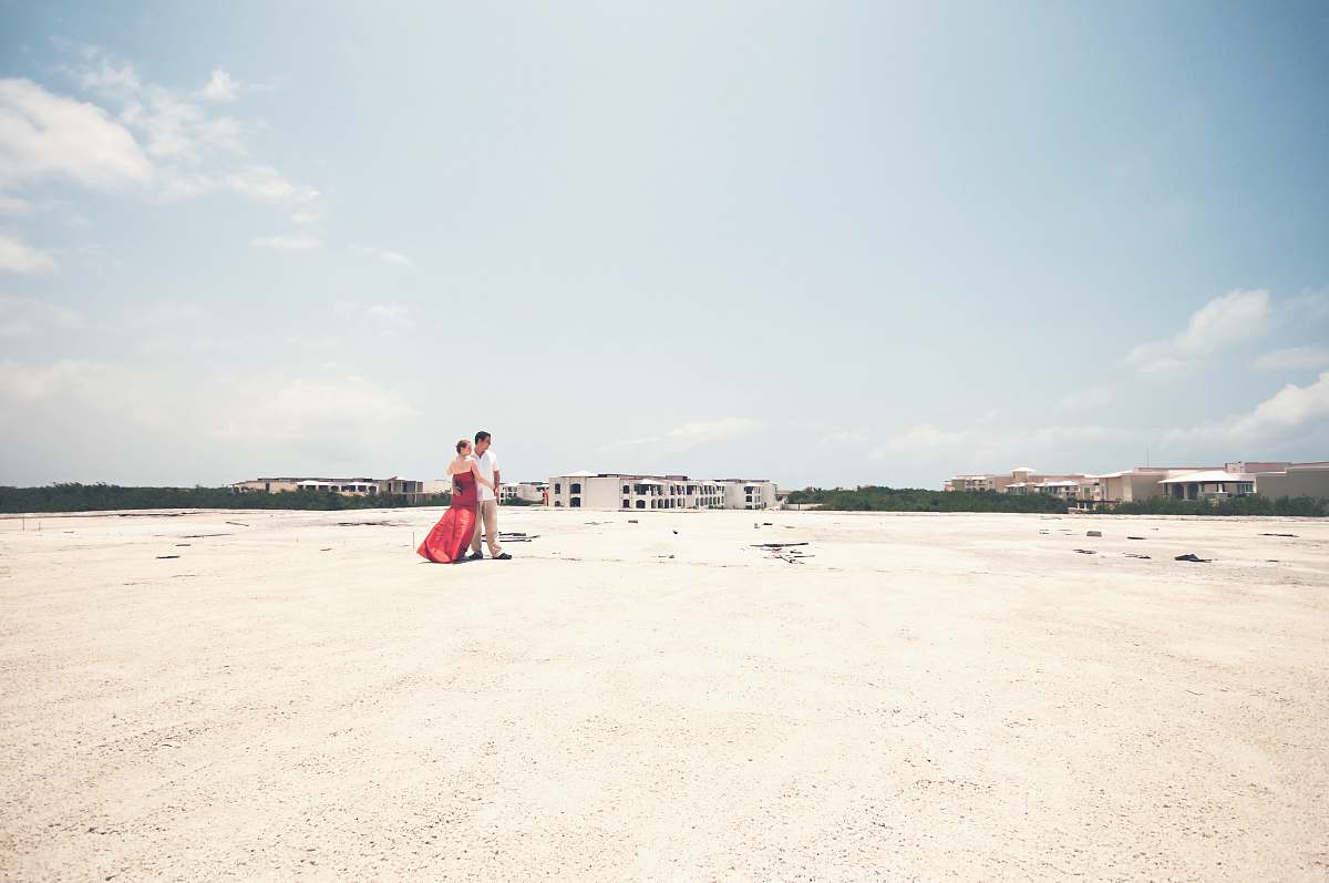 beach man and woman standing on open field during daytime coast
