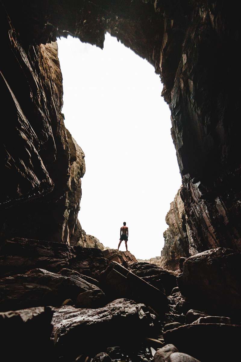 asturias man standing on cave cave