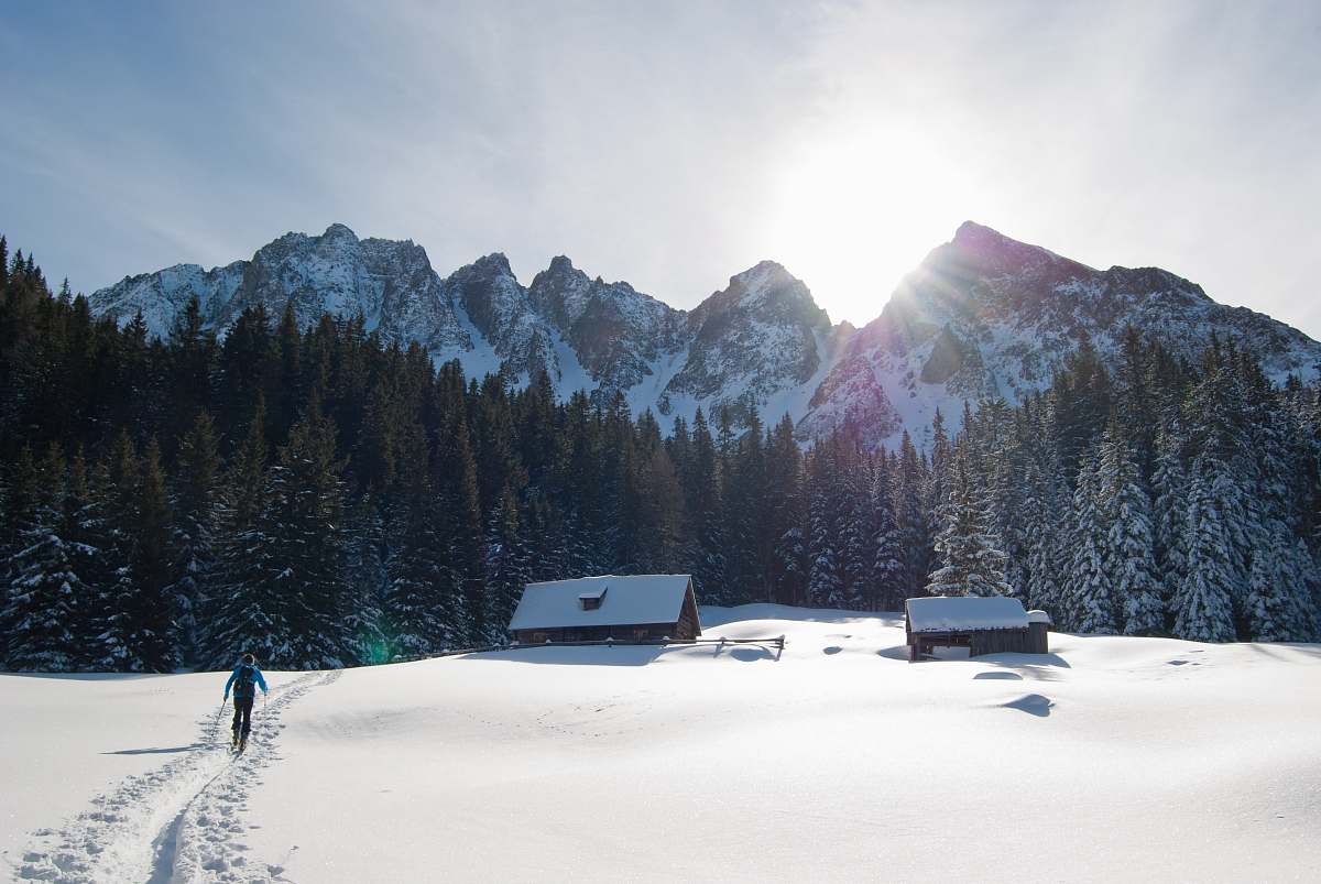winter person walking on snowfield near mountain range mountain range