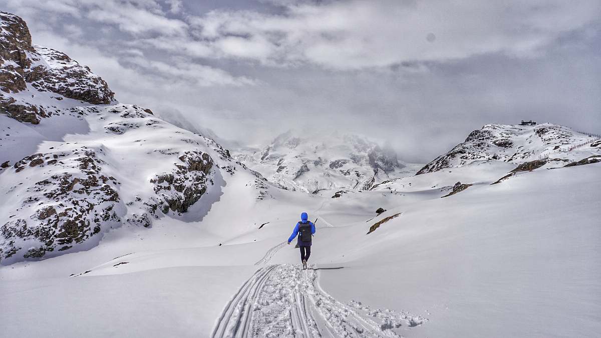 mountain person walking on snowy mountain snow
