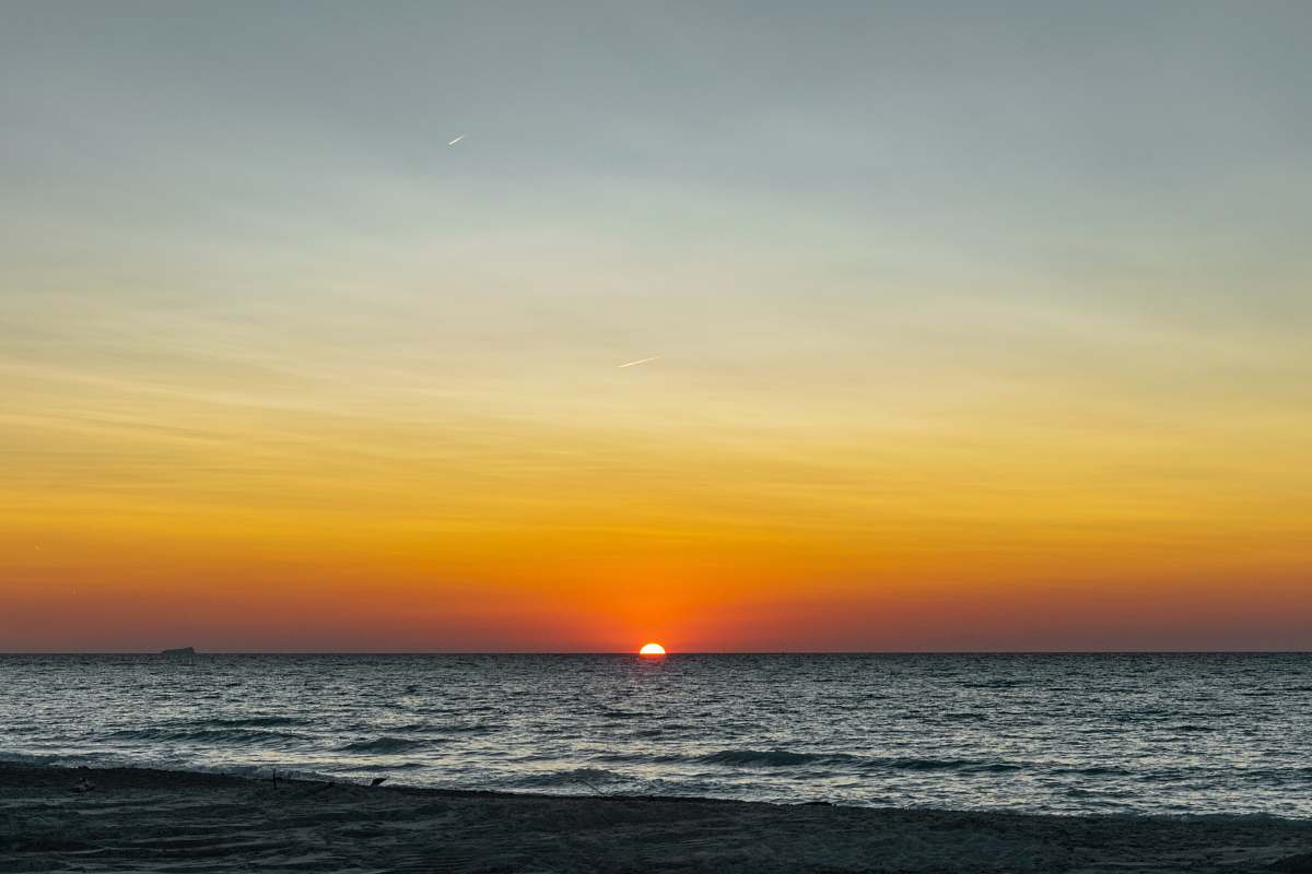 outdoors sea under gray sky during golden hour sky
