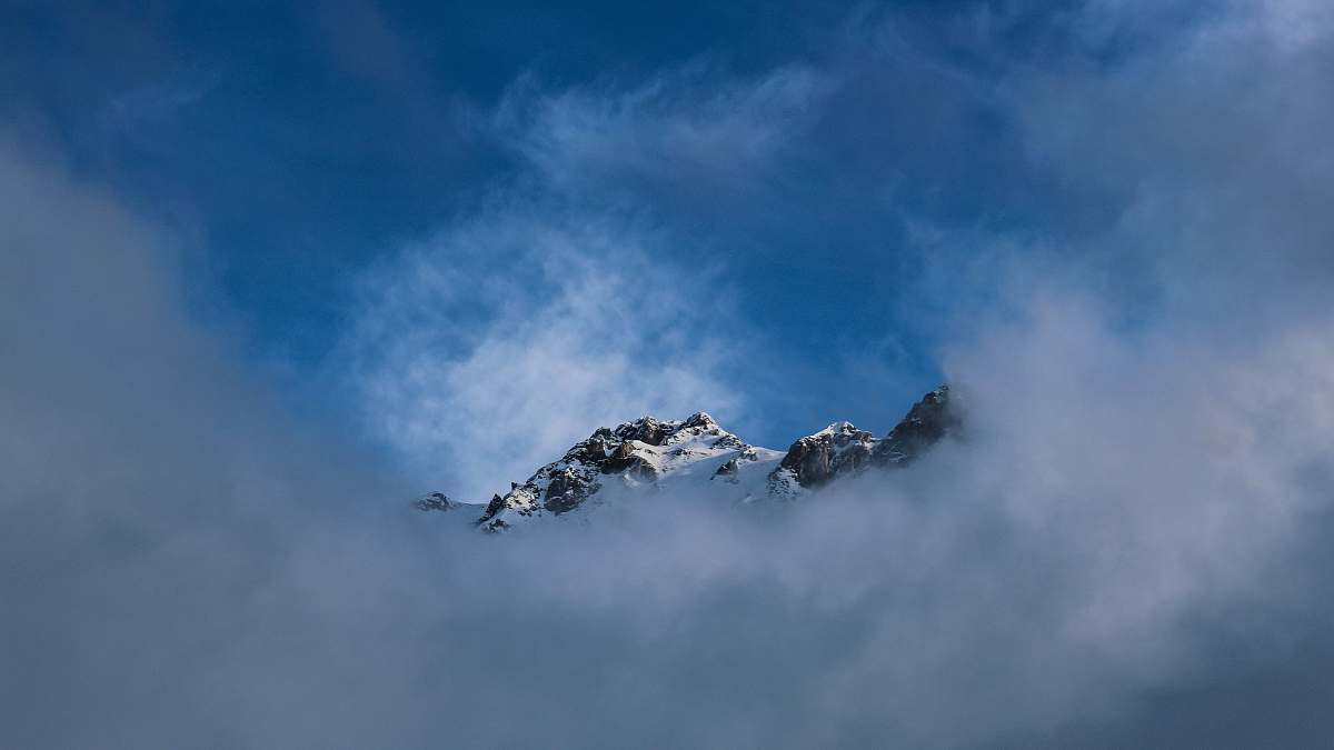 mountain snow top mountain covered with fog during daytime alps