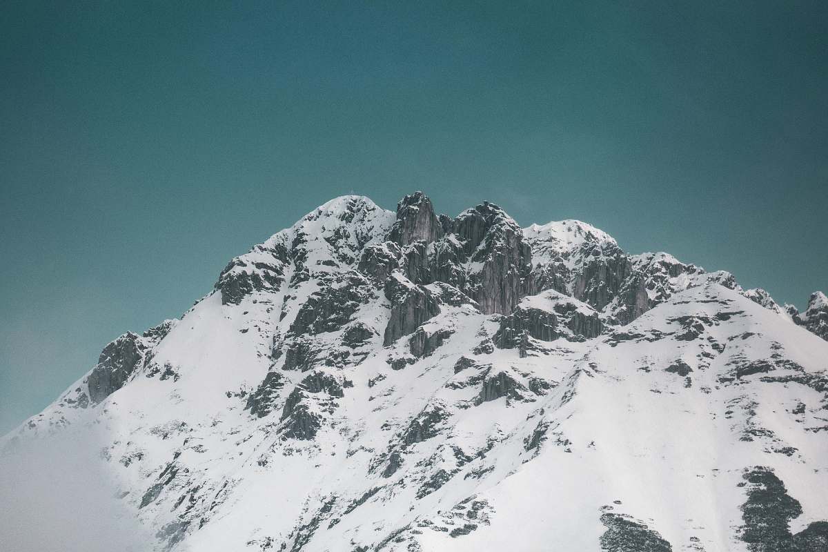 mountain snowy mountain under calm blue sky mountain range