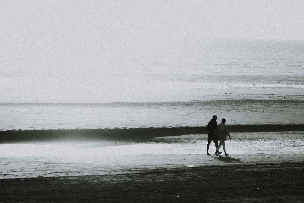 outdoors two person walking on seashore ocean
