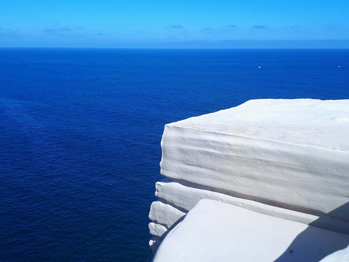 outdoors white snowy mountain cliff by the sea ice