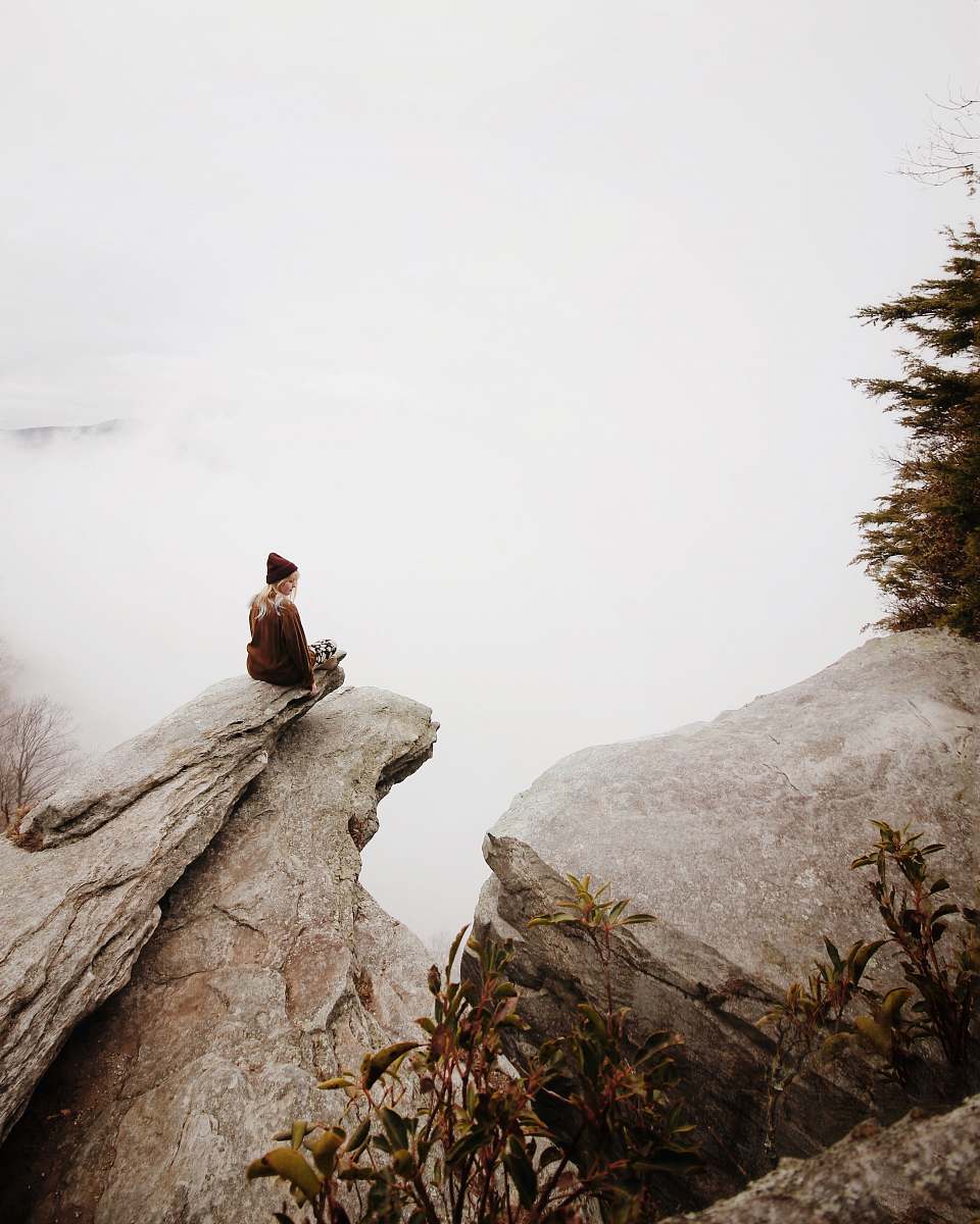 rock woman sitting on brown rock girl