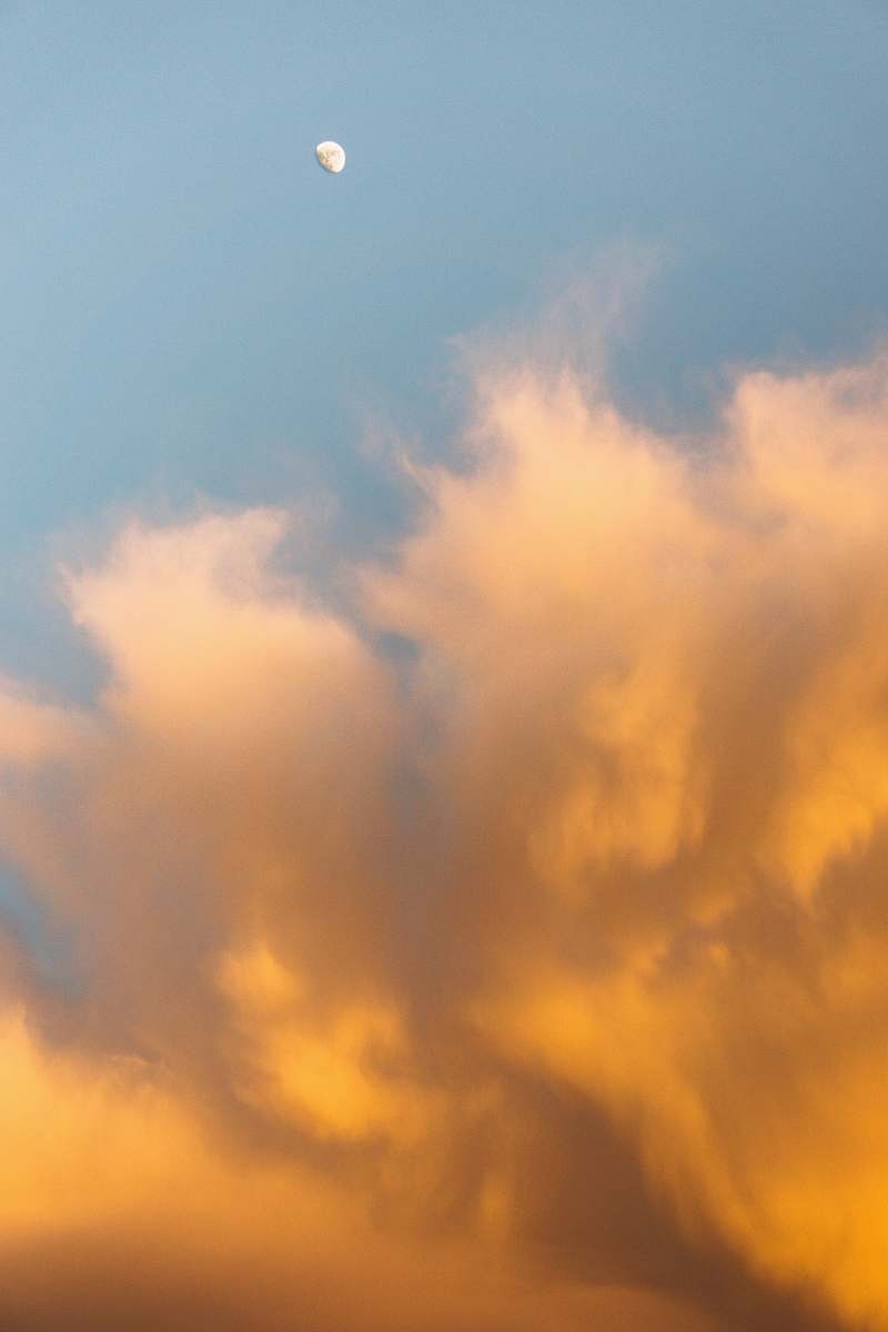 sky worm's-eye view of moon near clouds during daytime cloud