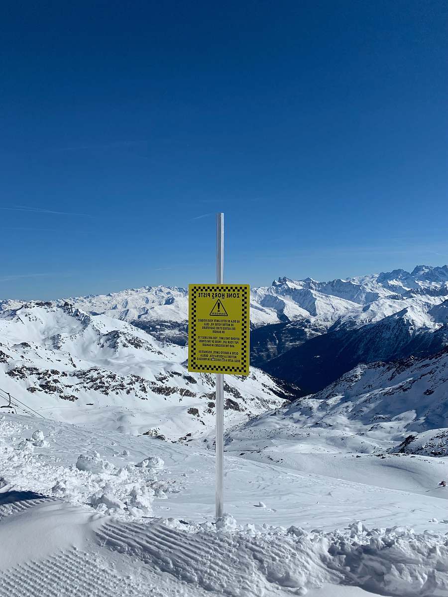 mountain yellow and black signage at mountain covered with snow outdoors