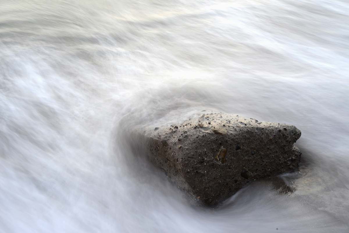 flow brown rock fragment and body of water rock