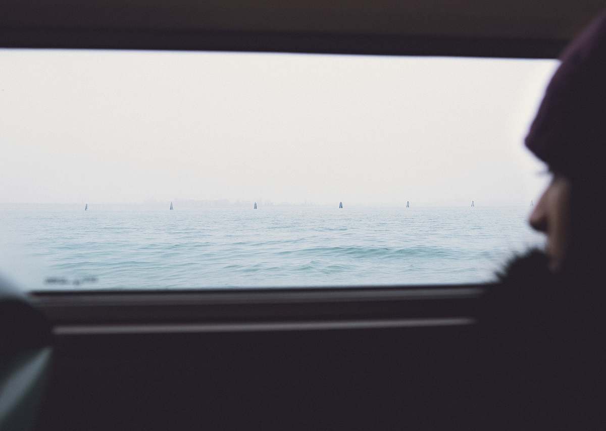 sea person inside vehicle looking at body of water water