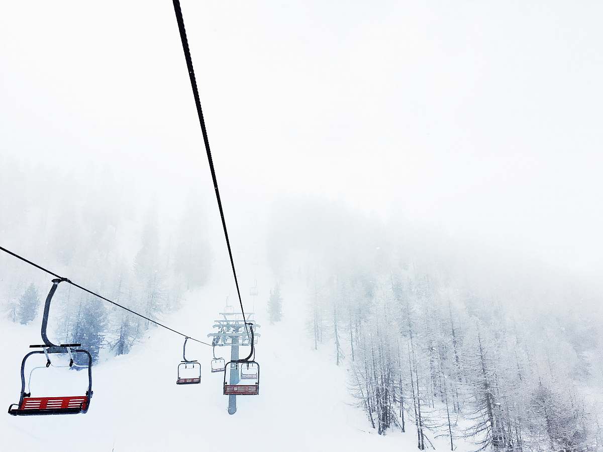 alps black and red ski lift near trees mountain