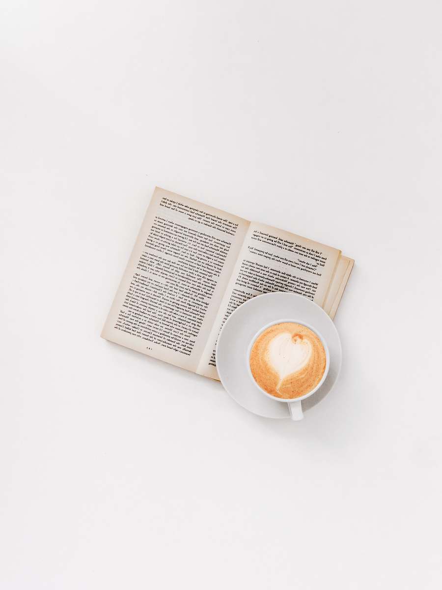 text cappuccino on brown book reading
