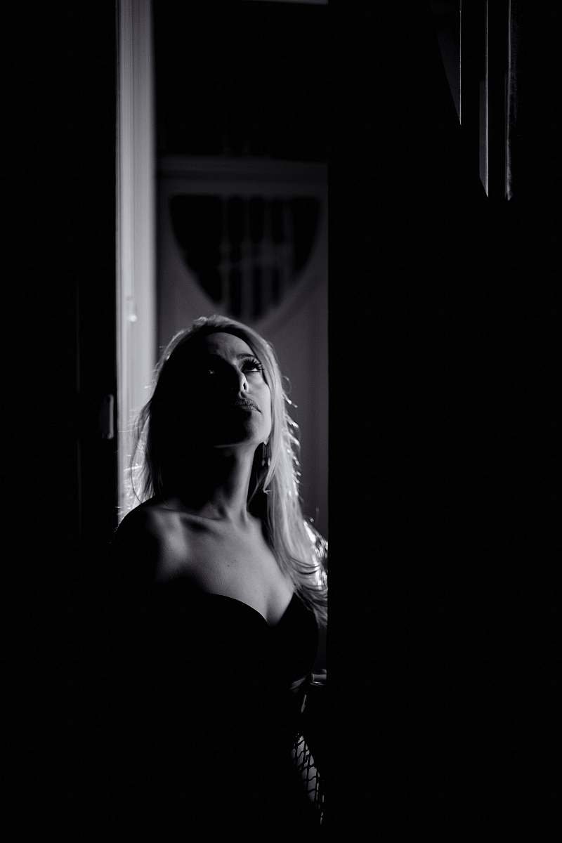 human greyscale photo of woman looking at ceiling person