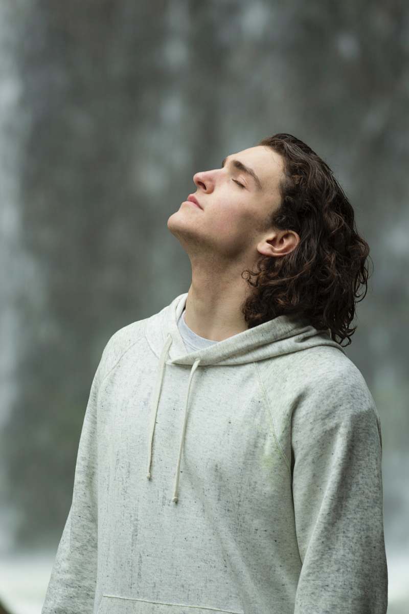 portrait man in gray pullover hoodie closed eyes while heads up human