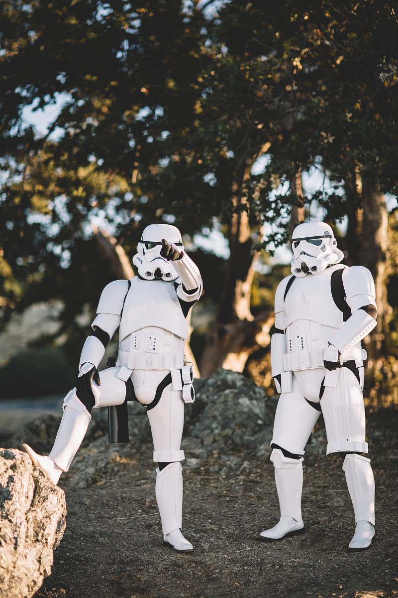 person two Star Wars Stormtrooper action figures on gray surface outdoors human