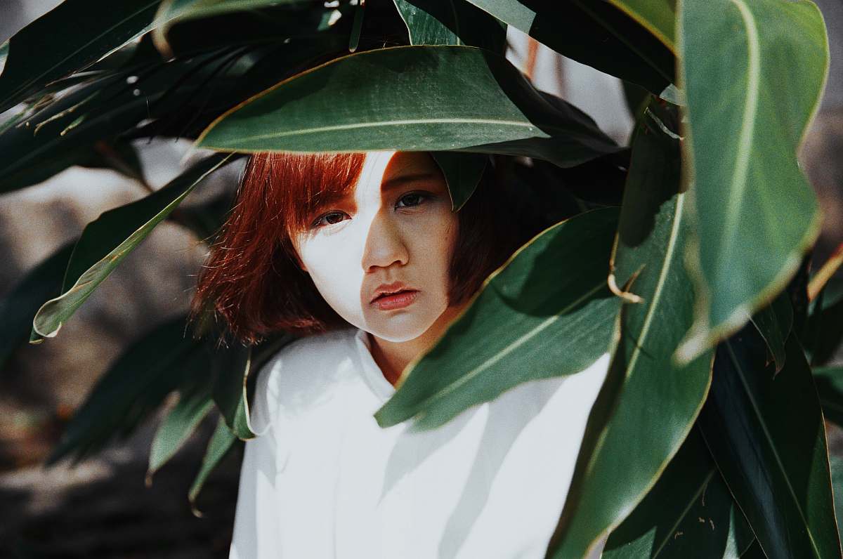 plant woman hiding under green leaf tree female