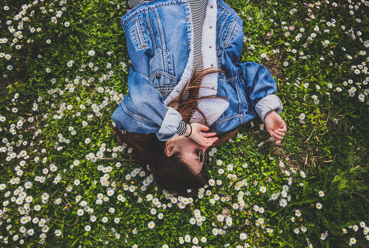 person woman lying on bed of white petaled flower human