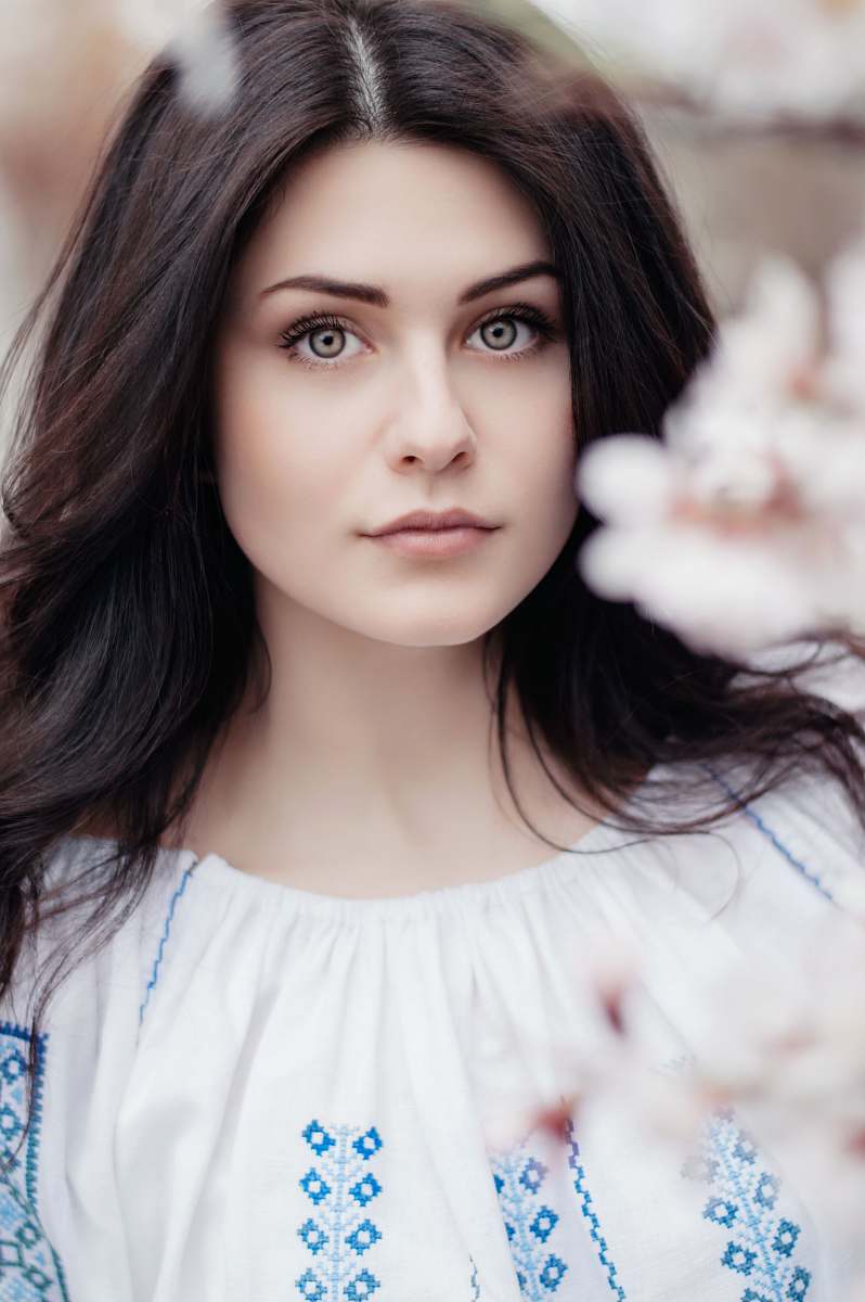 woman woman standing near white petaled flower girl
