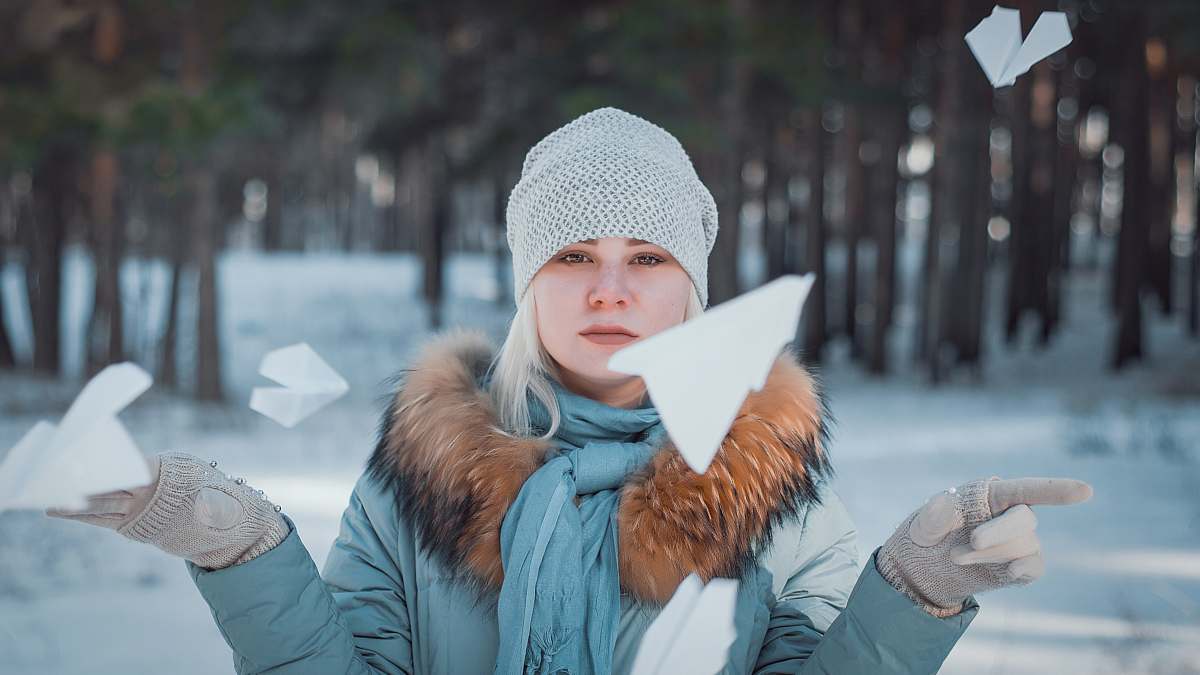 human woman surrounded by flying paper plane person