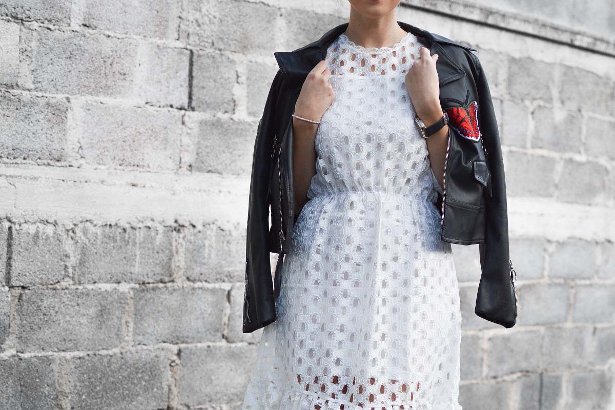 person woman with coat beside cinder block wall human