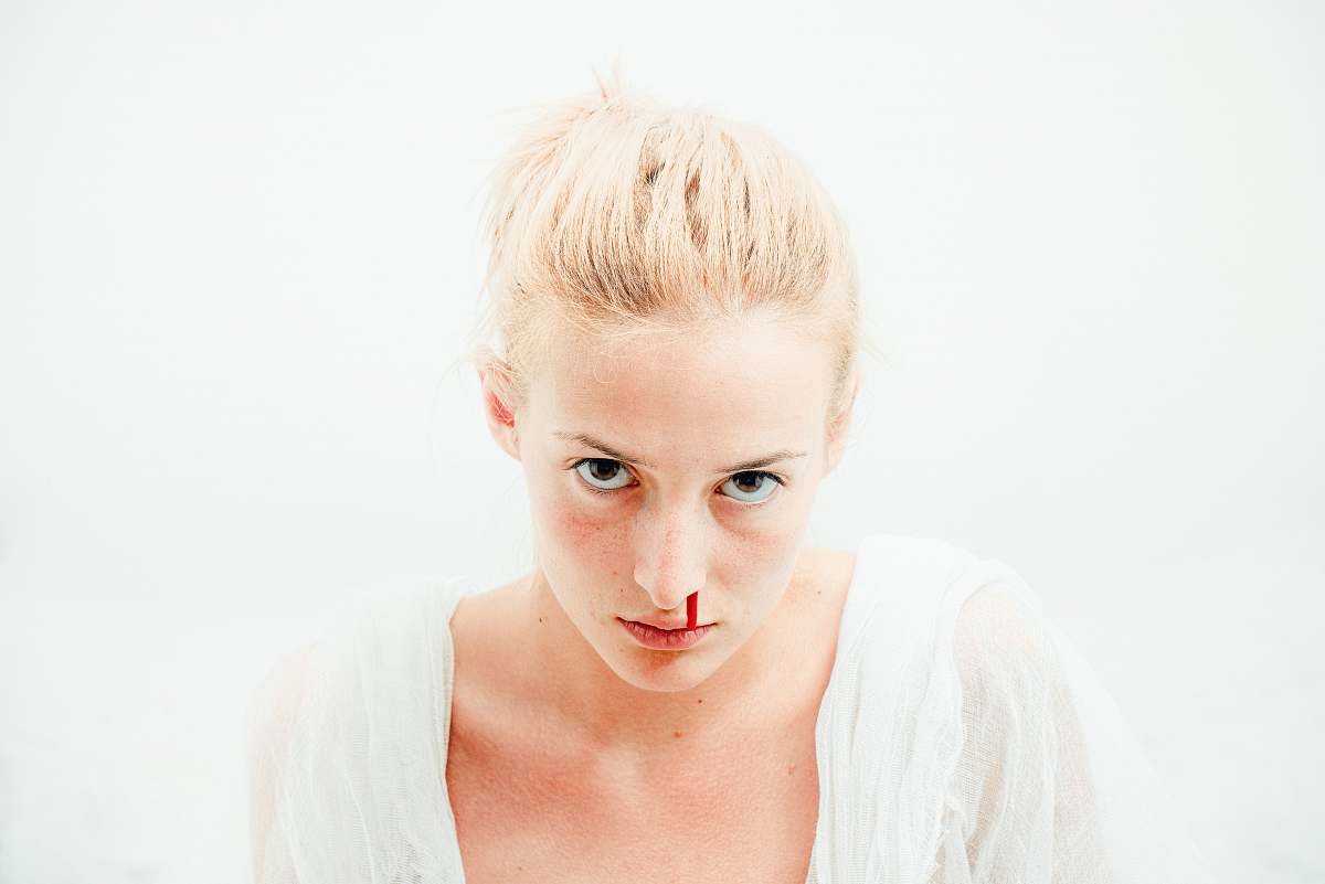 human woman's bleeding nose with white background person