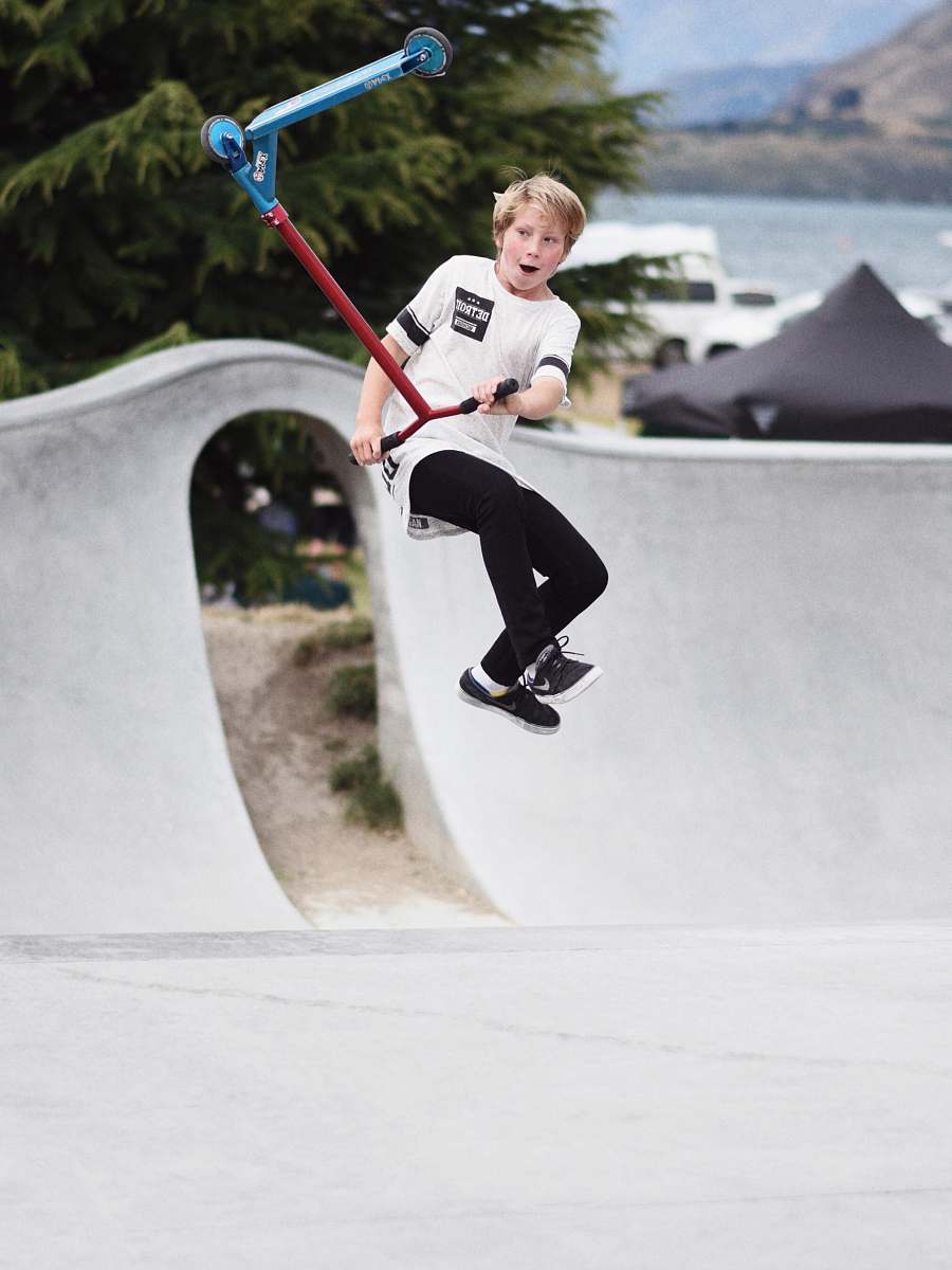 human boy jumping off from red scooter people