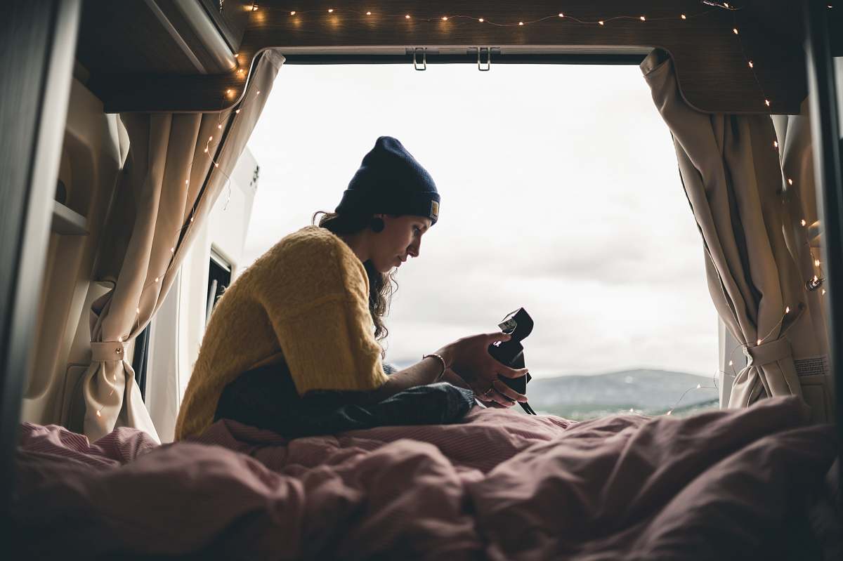 human girl sitting on bed near window during daytime people