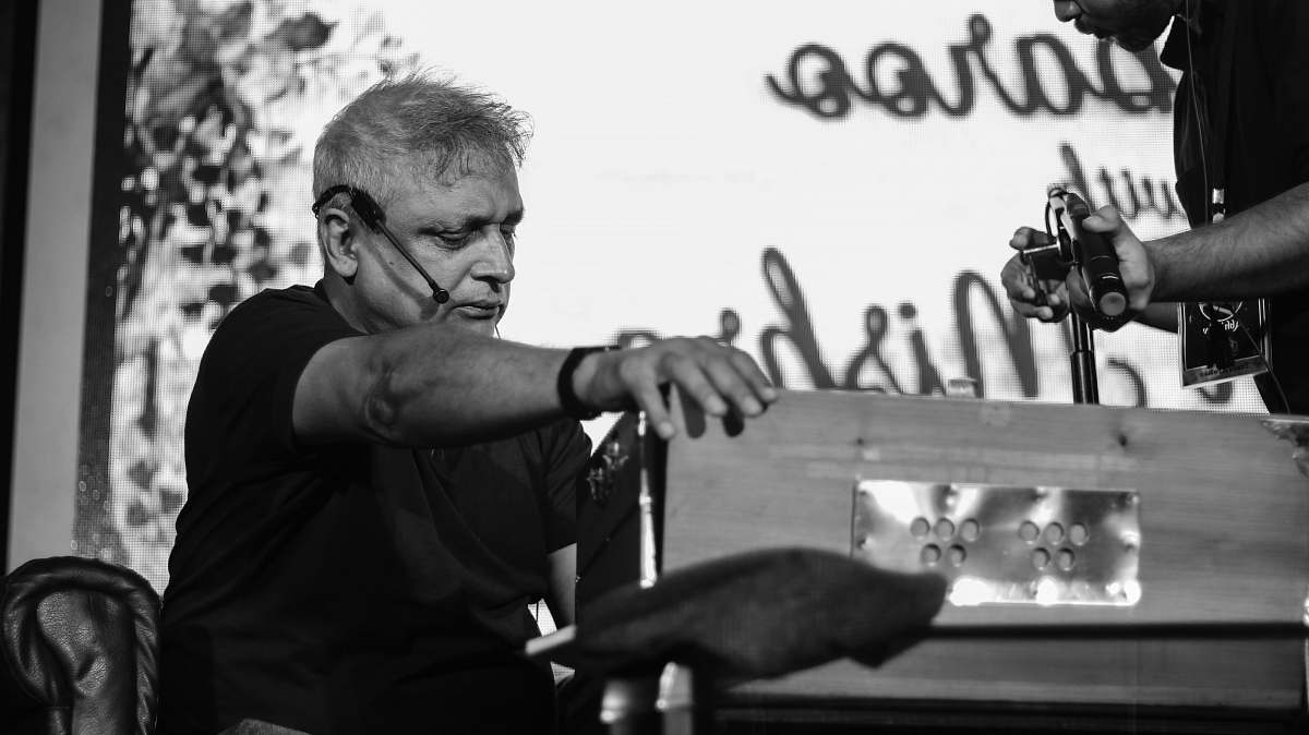 human grayscale photo of man near box black-and-white
