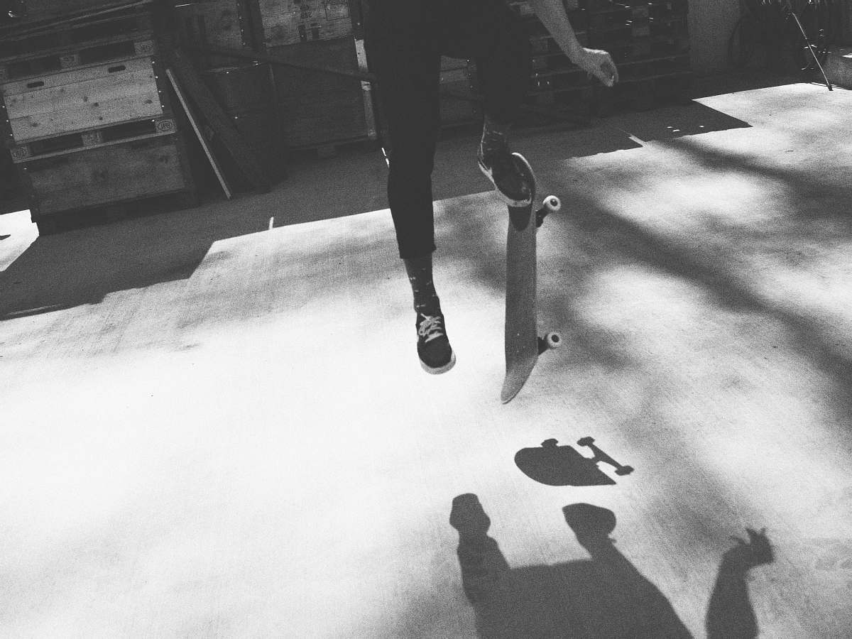 white grayscale photography of person doing skateboard tricks black-and-white