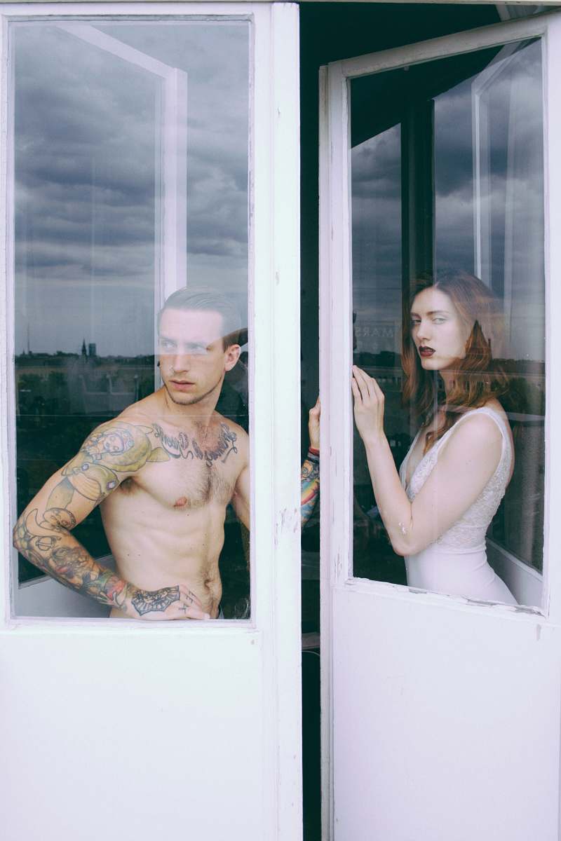 human man and woman standing beside the door people