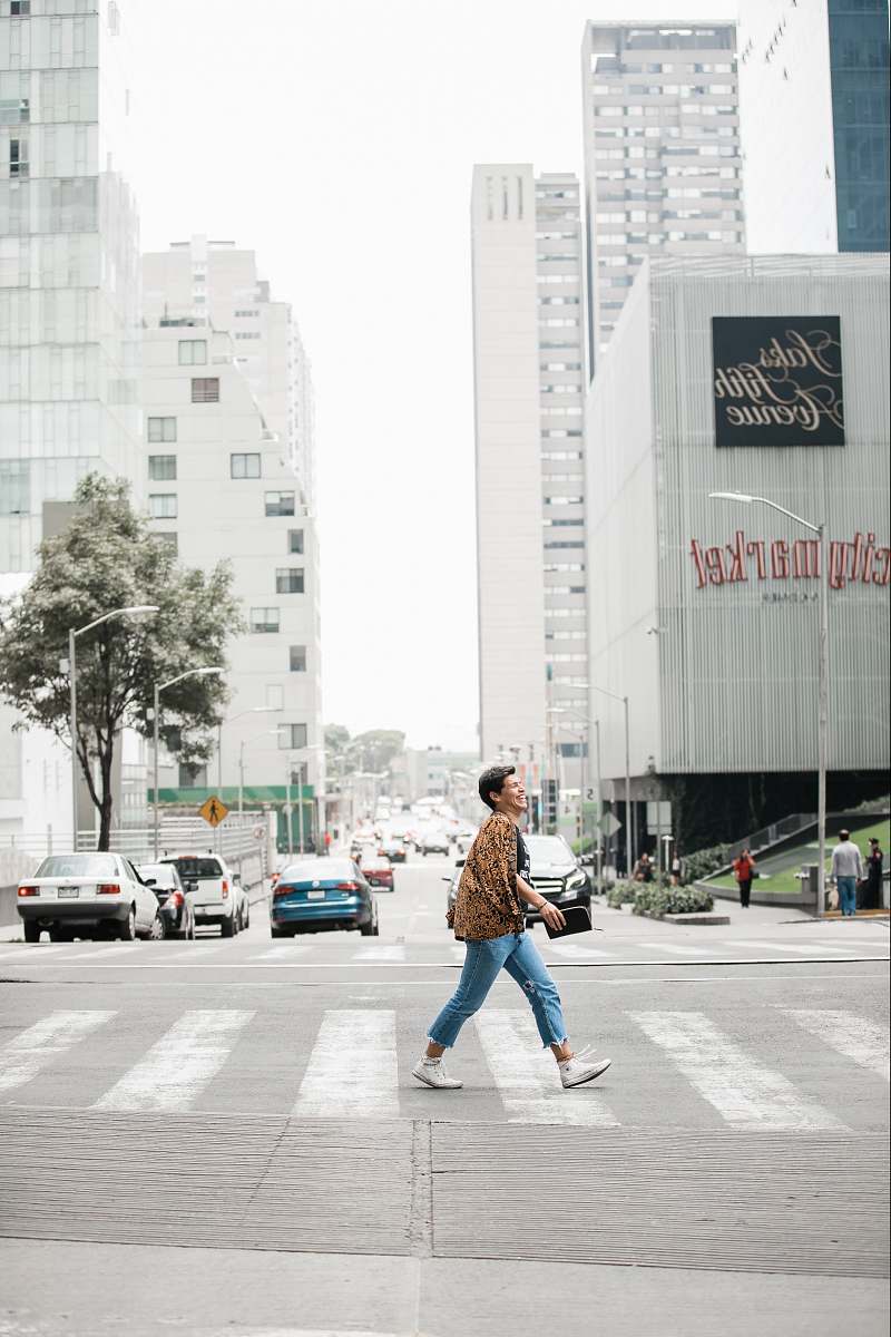 human man in brown jacket walking on pedestrian lane people